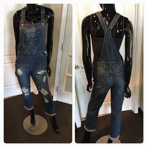 Distressed denim overalls